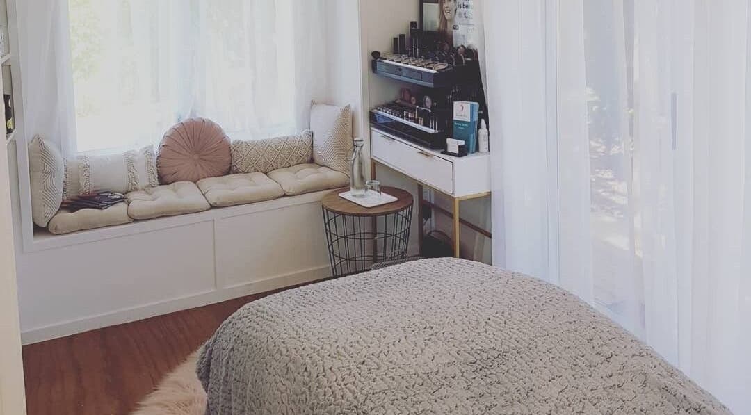 Relaxing spa room at Inside Out Beauty, Waipapa, Northland, NZ with cozy seating and elegant decor.