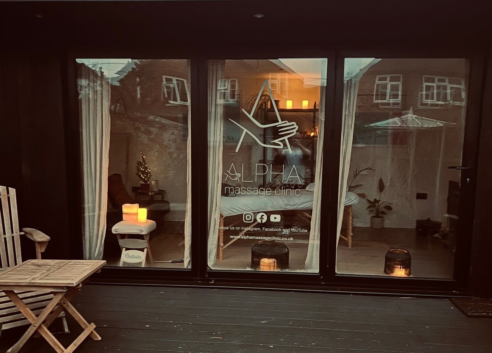 Inviting entrance of Alpha Massage - Chobham Clinic, Chobham, England, GB with cozy decor and warm lighting.