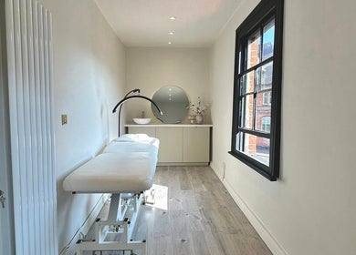 Elegant treatment room at Shaw Beauty, Sandbach, England, GB with a massage table and modern decor.