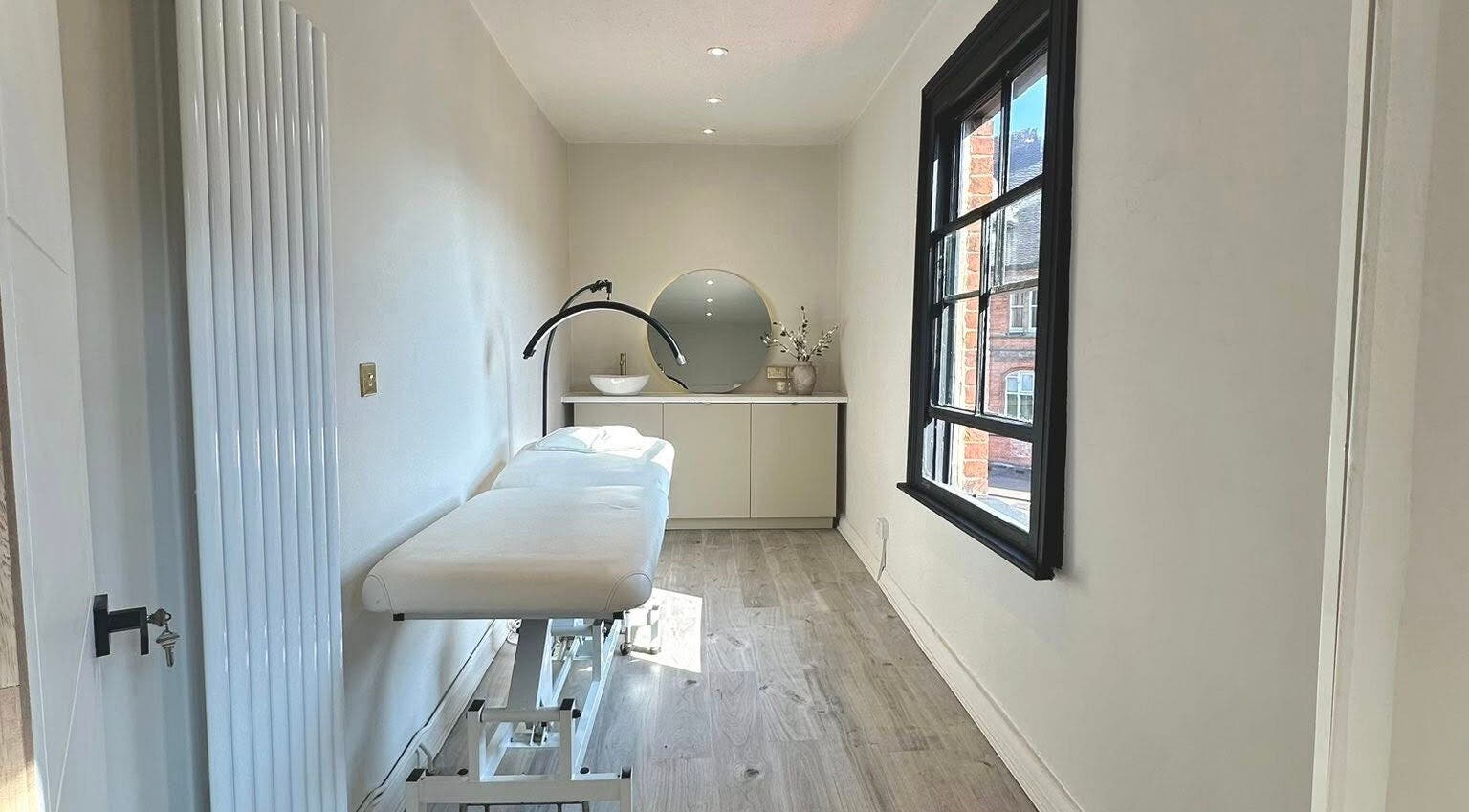 Elegant treatment room at Shaw Beauty, Sandbach, England, GB with a massage table and modern decor.