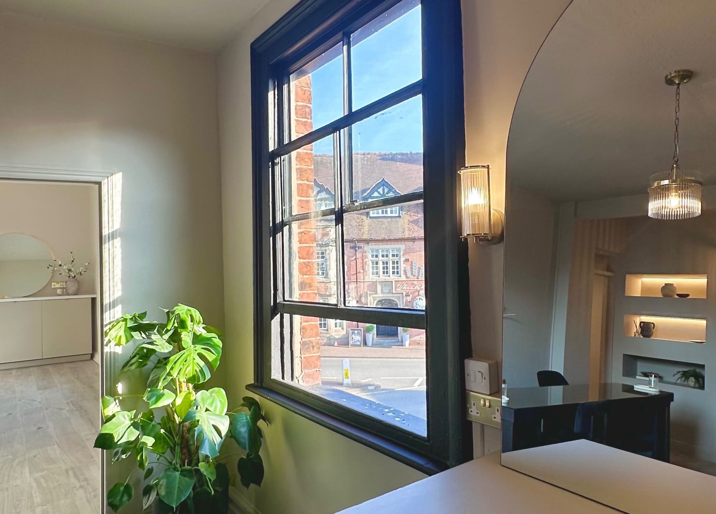 Bright interior of Shaw Beauty, Sandbach, England, GB with large window and plants.