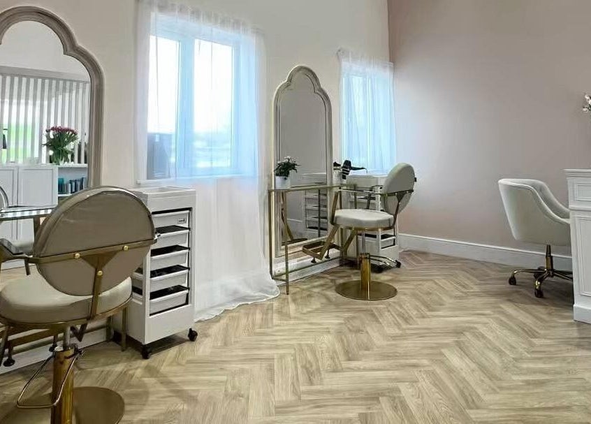 Elegant hair styling station at By Becky Studios, Wells, England, GB, featuring chic mirrors and plush chairs.