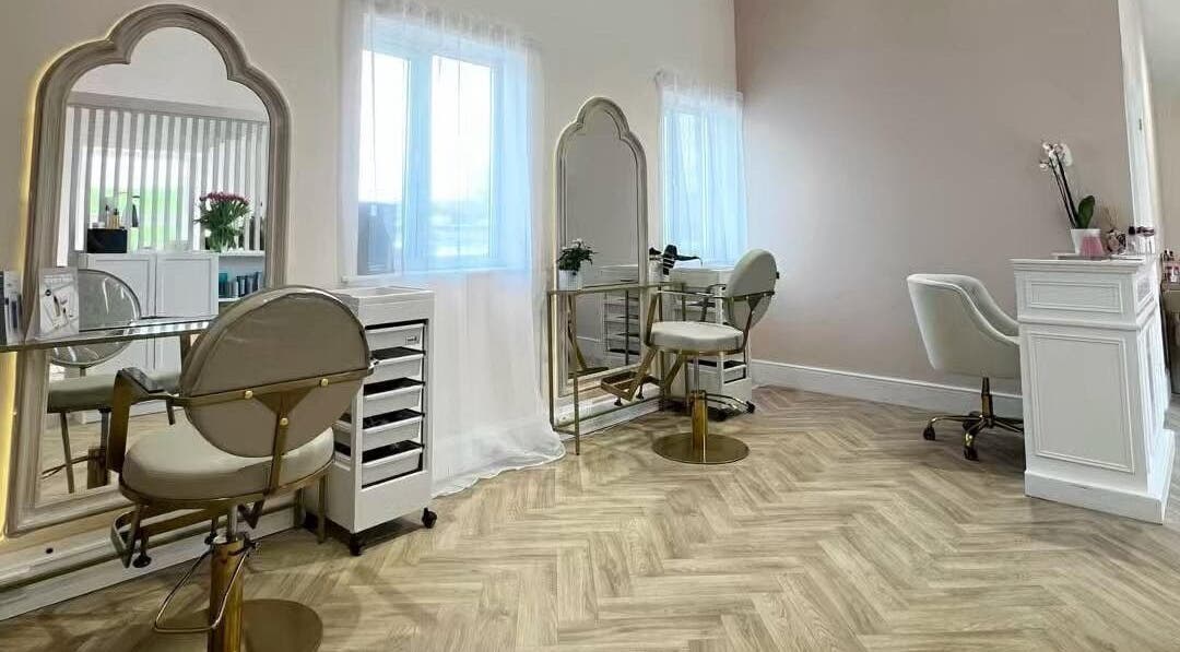 Elegant hair styling station at By Becky Studios, Wells, England, GB, featuring chic mirrors and plush chairs.