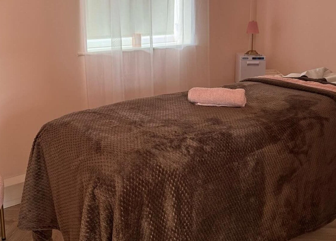 Elegant treatment room at By Becky Studios in Wells, England, GB featuring a plush massage table.