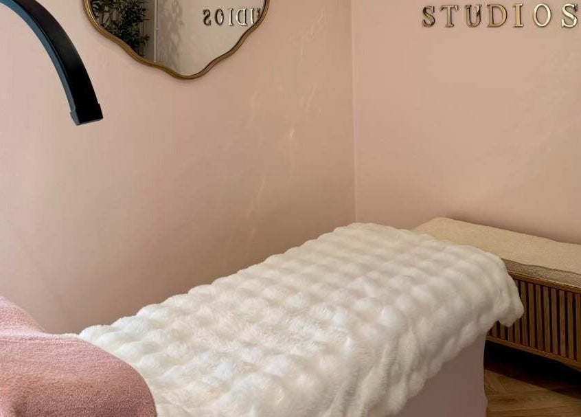 Cozy massage room at By Becky Studios, Wells, England, GB, with soft lighting and elegant decor.