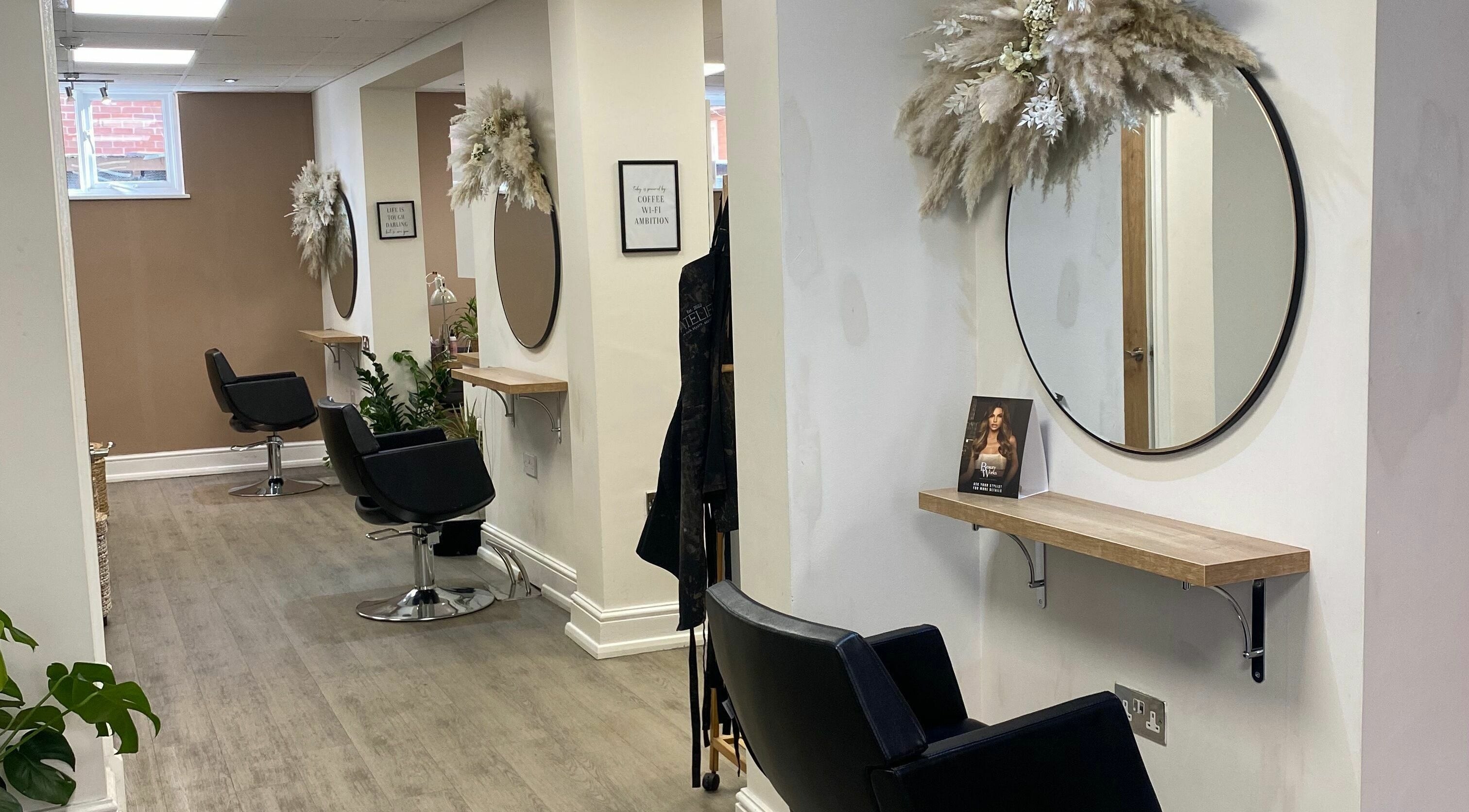 Modern salon chairs and mirrors at Atelier in Worcestershire, England, GB showcase elegance and style.
