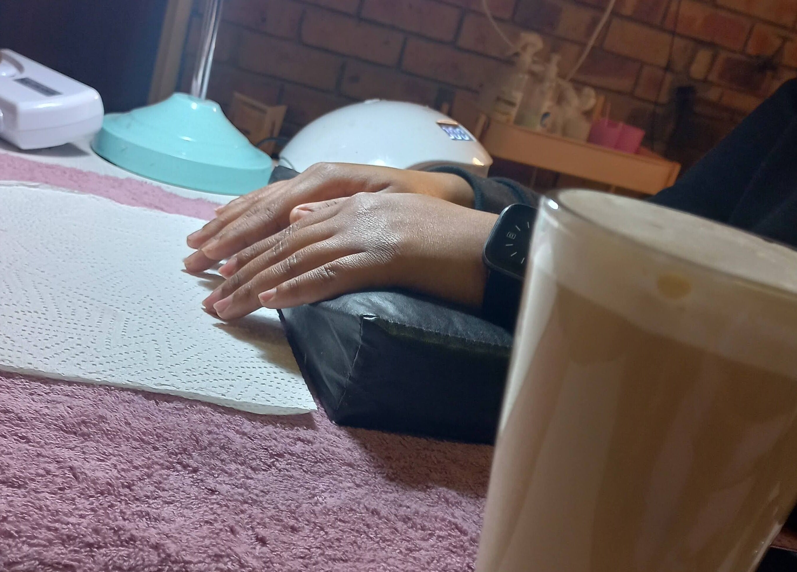 Cozy manicure setup at Nnah_Vee Beauty, Kimberley, Northern Cape, ZA with coffee and tools.