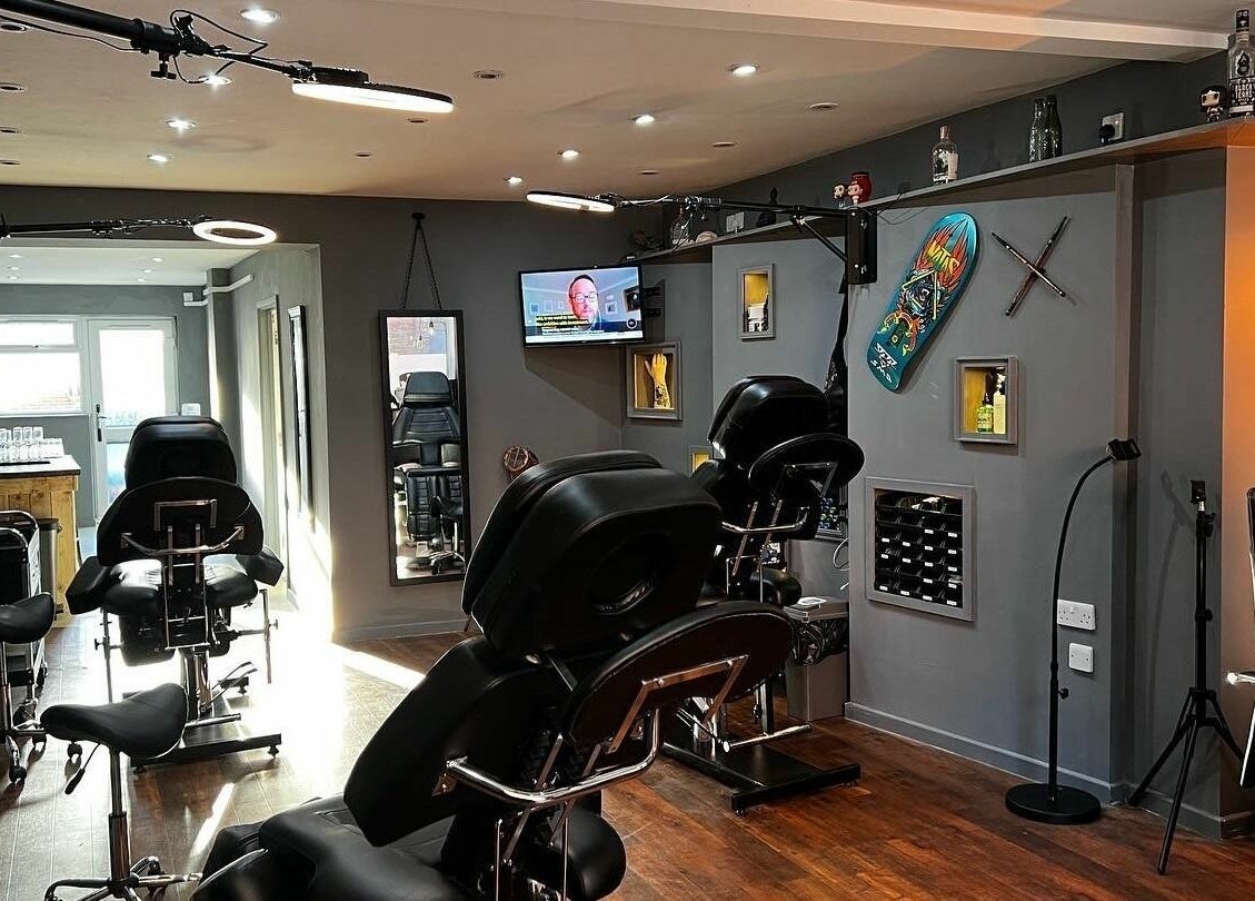 Modern tattoo studio at Black Heart Ink, Swindon, England, GB showcasing stylish seating and decor.