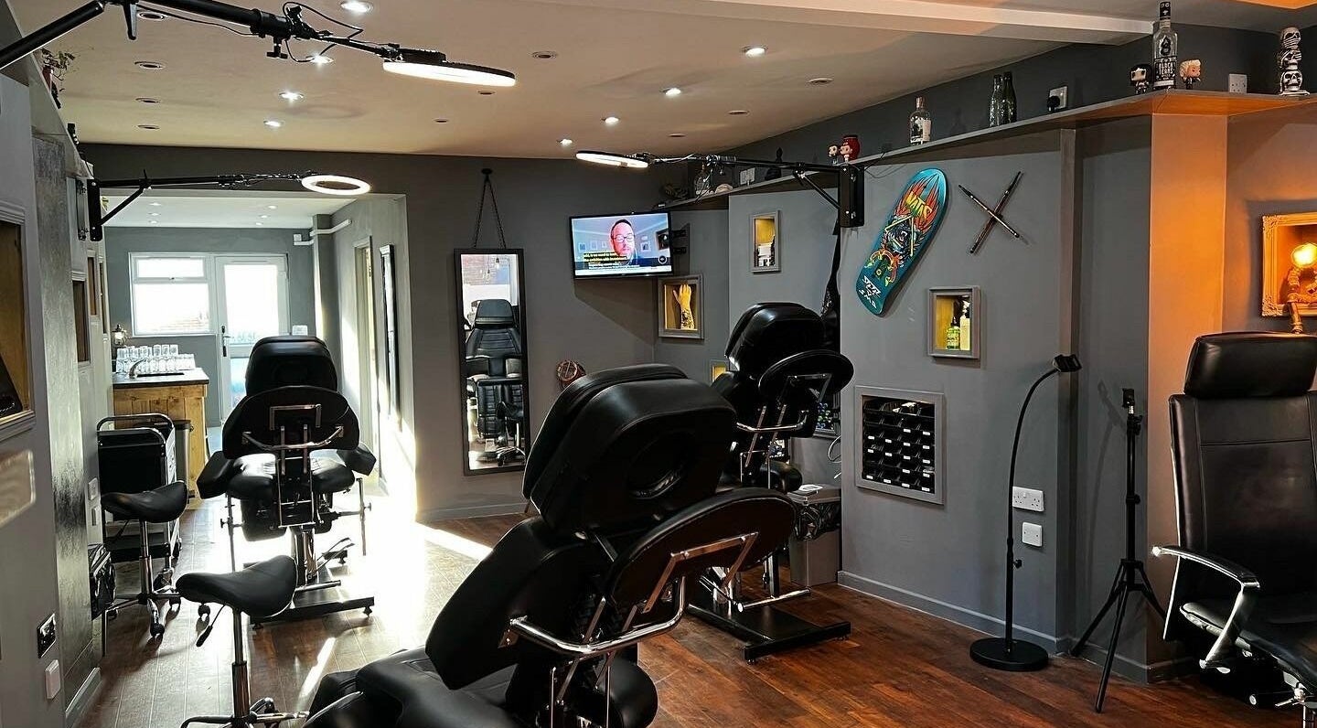 Modern tattoo studio at Black Heart Ink, Swindon, England, GB showcasing stylish seating and decor.
