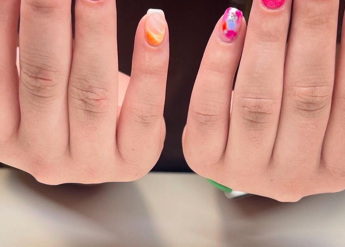Colorful nail art at Nails By Elli in Bryan, Ohio, US showcasing vibrant design and creativity.