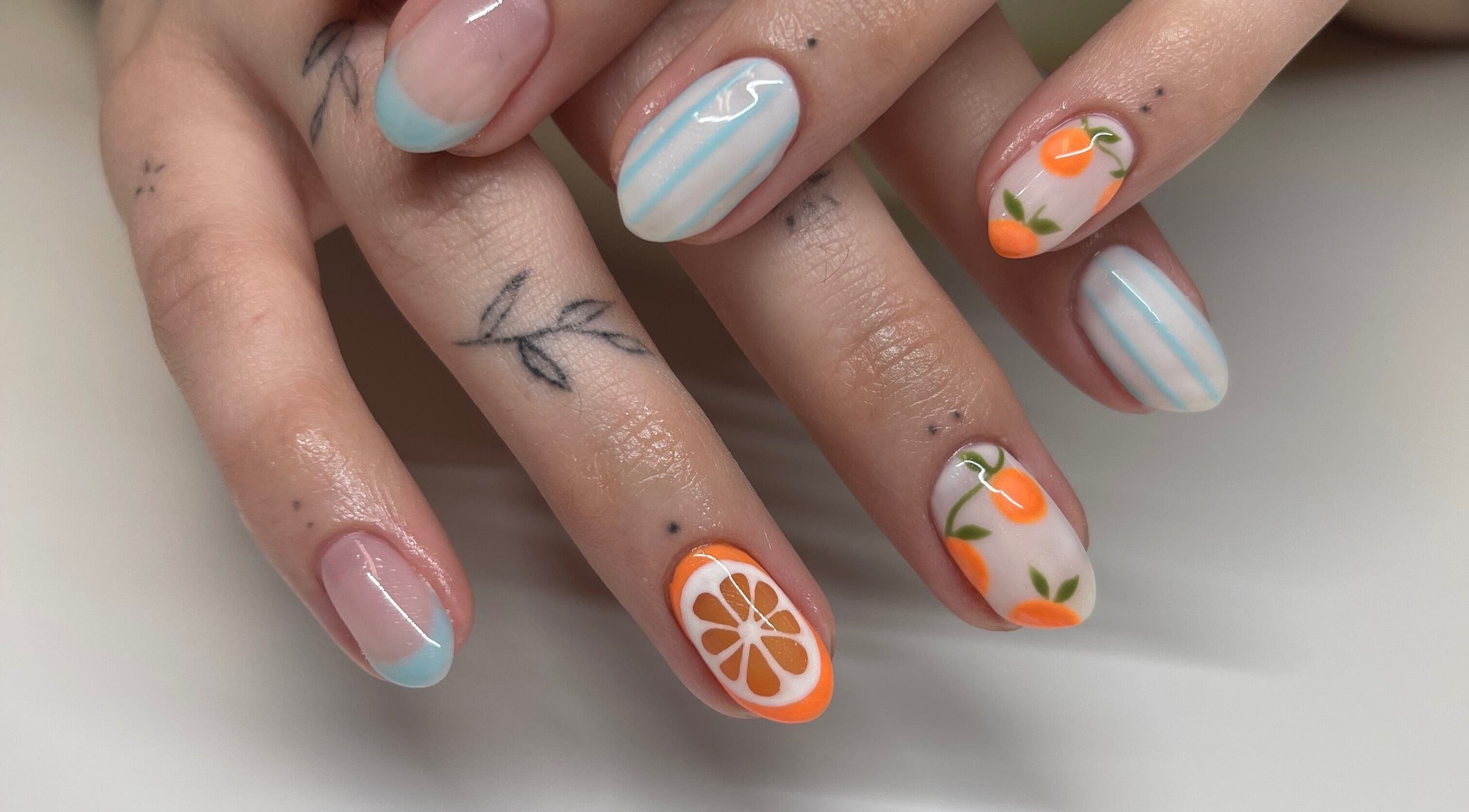 Vibrant citrus-themed nail art by Nails By Elli in Bryan, Ohio, US, featuring delicate blue stripes.