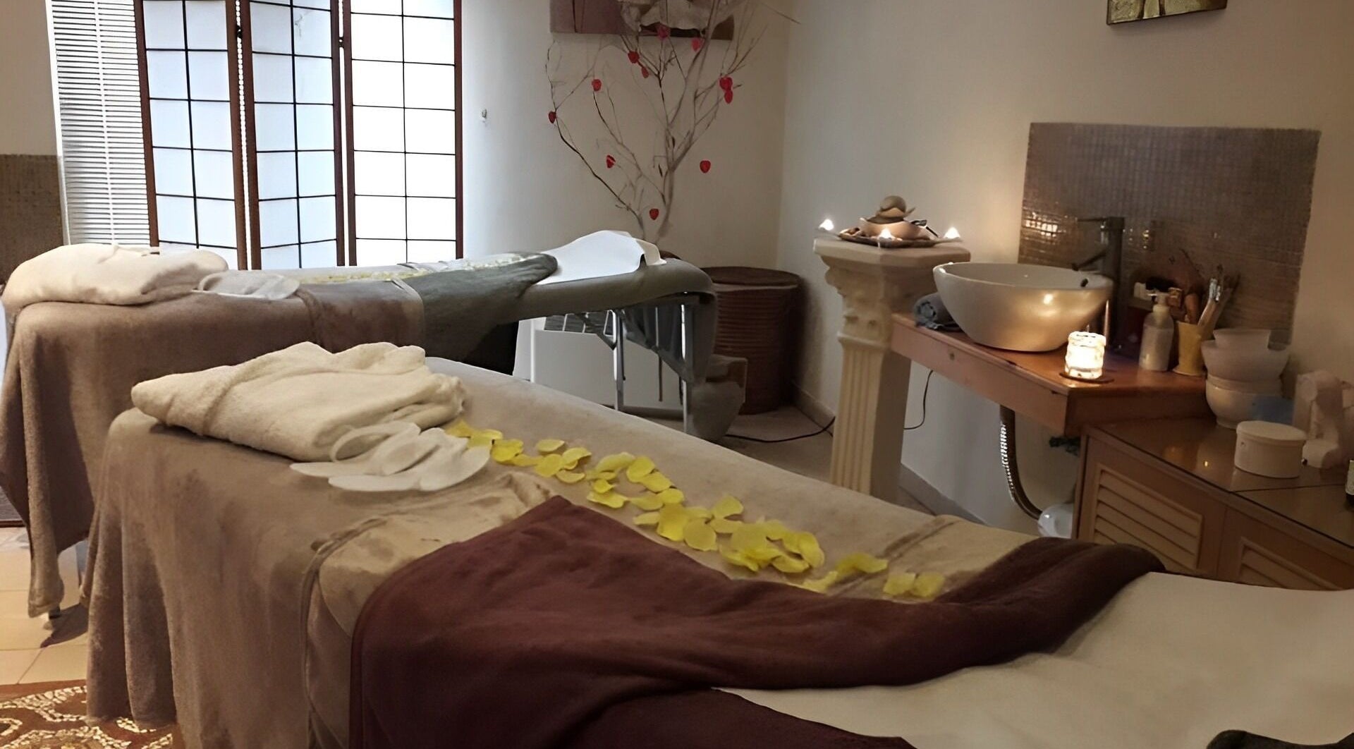 Relaxing massage room at Vanita' Beauty & Wellness Spa, Birkirkara, MT, with two beds and soft lighting.