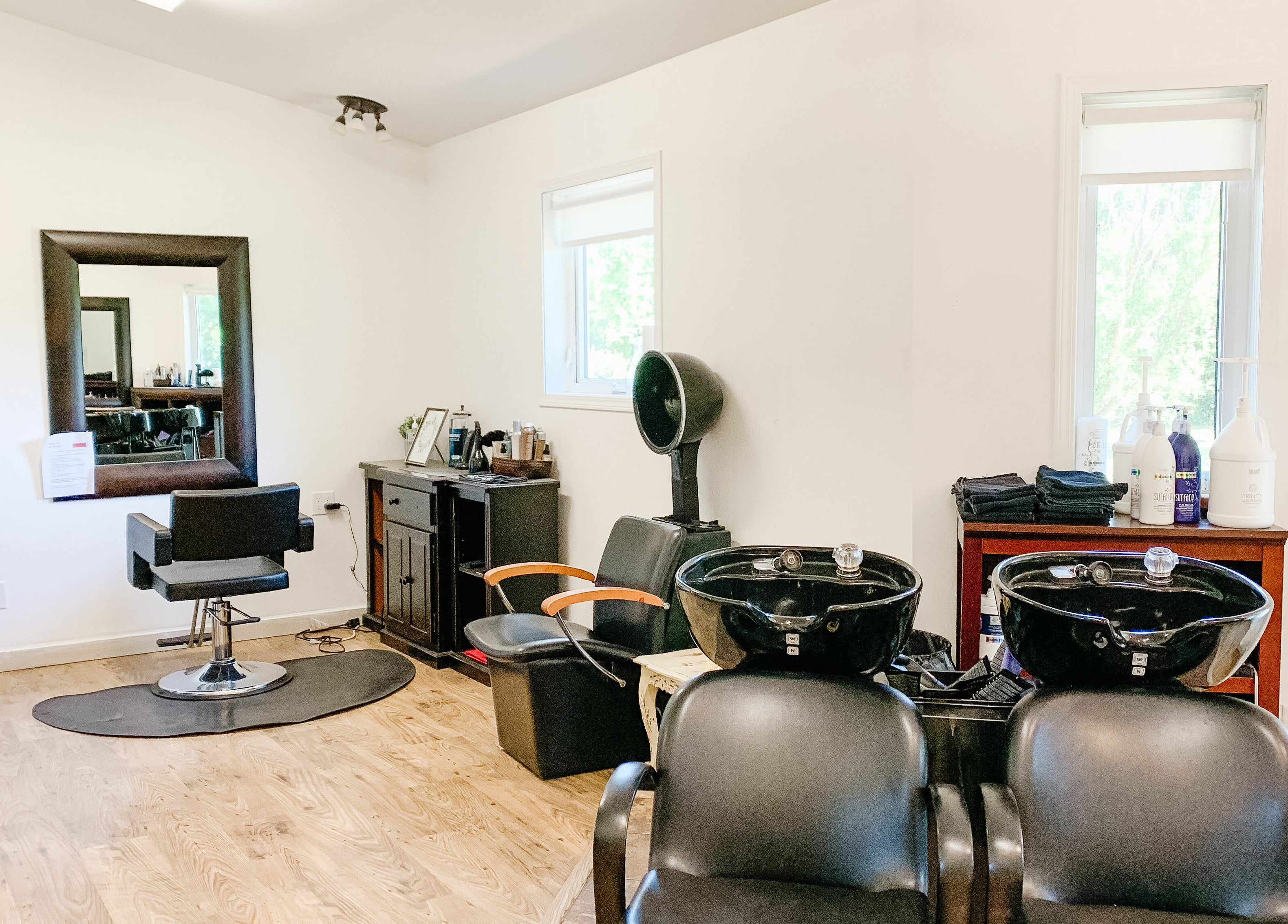 Modern salon interior at Classic Impressions Salon in Grunthal, Manitoba, CA featuring styling and washing stations.