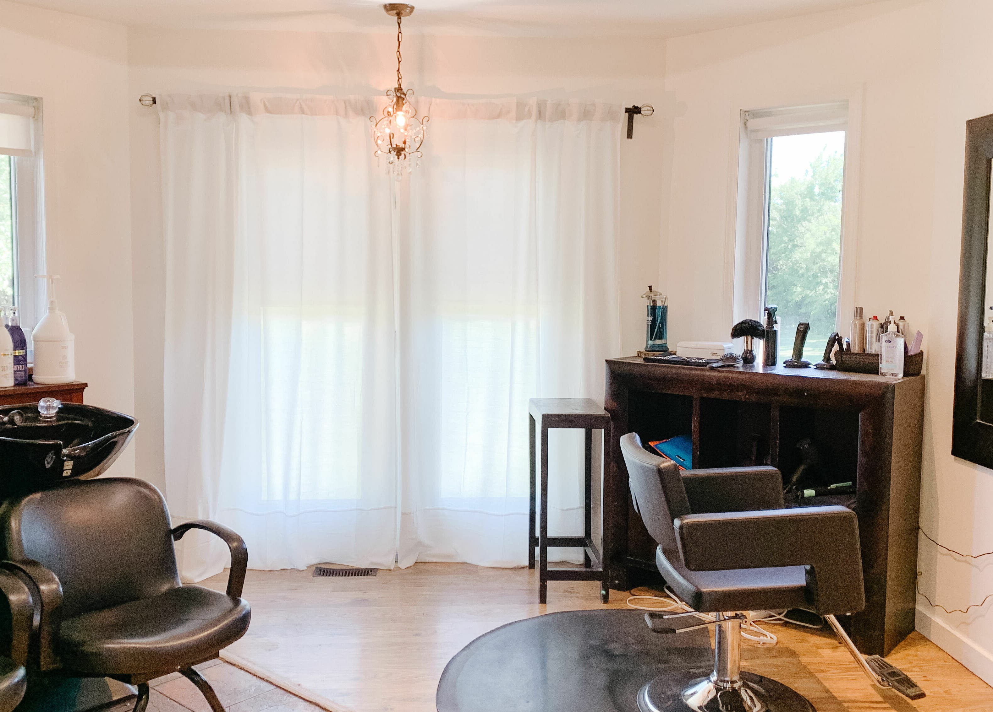 Modern styling area at Classic Impressions Salon in Grunthal, Manitoba, CA, featuring sleek chairs and equipment.