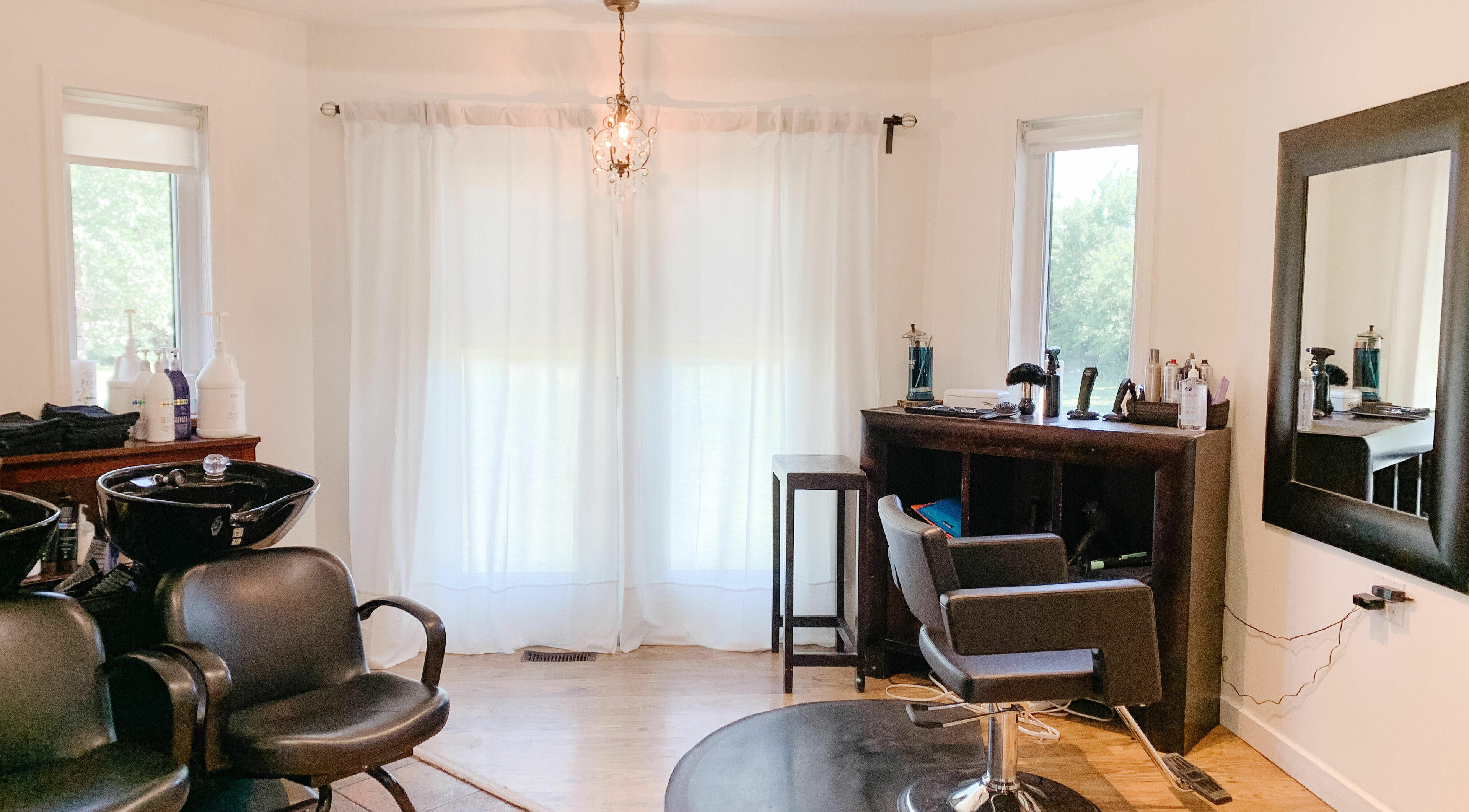Modern styling area at Classic Impressions Salon in Grunthal, Manitoba, CA, featuring sleek chairs and equipment.