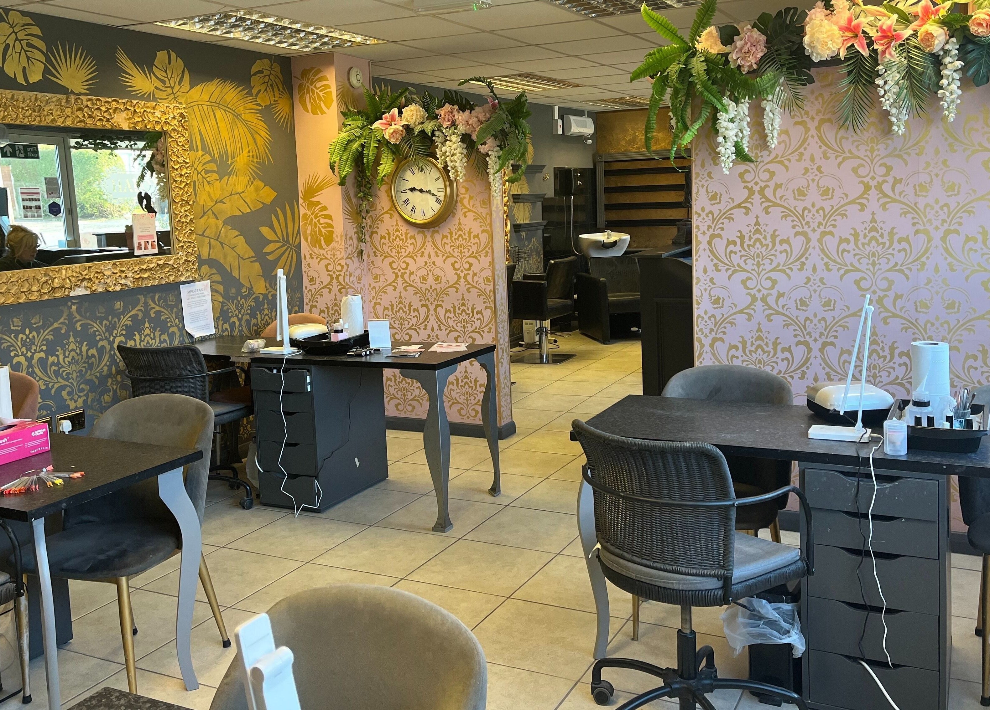 Chic nail salon interior at Halo, Newcastle-under-Lyme, England, GB, featuring floral decor and stylish furnishings.