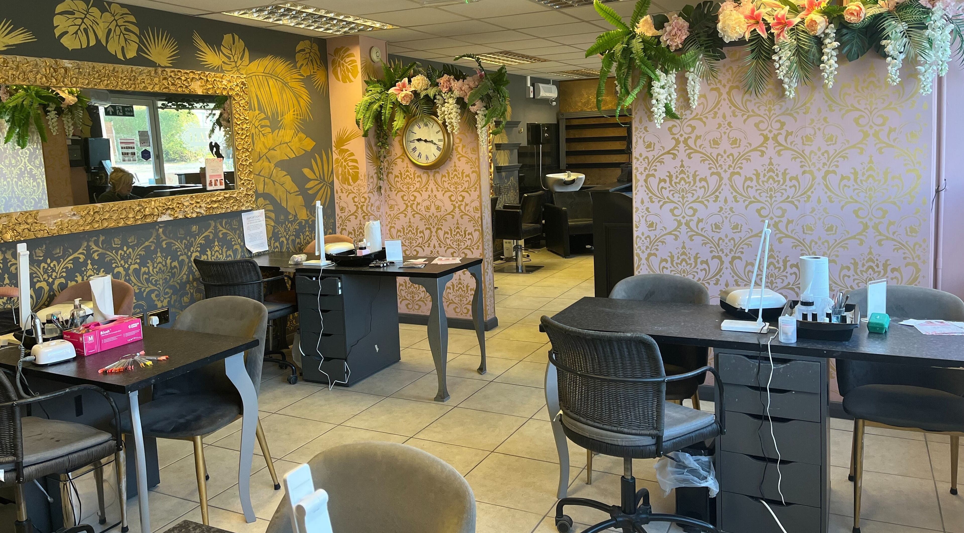 Chic nail salon interior at Halo, Newcastle-under-Lyme, England, GB, featuring floral decor and stylish furnishings.