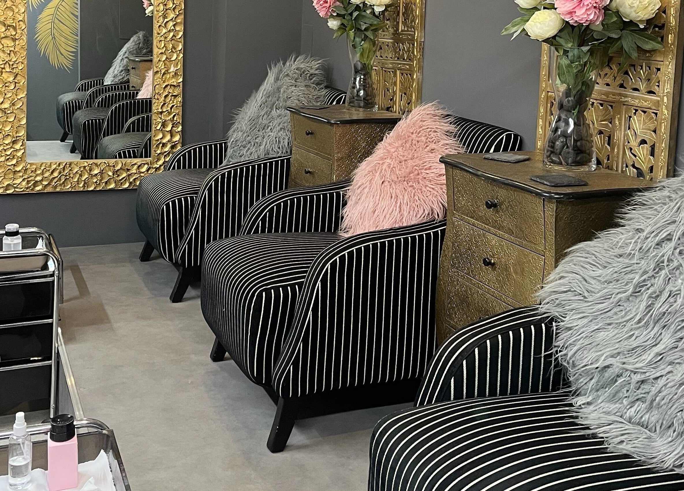 Luxurious striped seating at Halo in Newcastle-under-Lyme, England, GB with opulent gold decor and soft cushions.