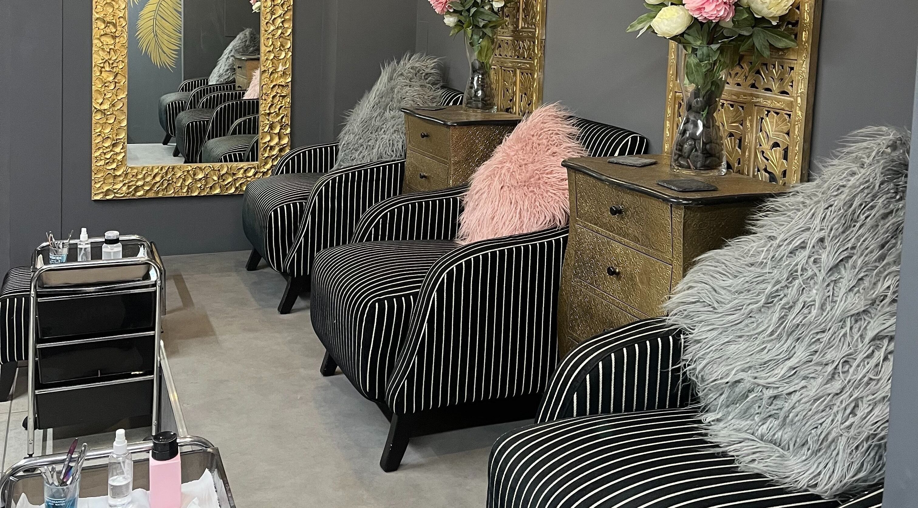 Luxurious striped seating at Halo in Newcastle-under-Lyme, England, GB with opulent gold decor and soft cushions.