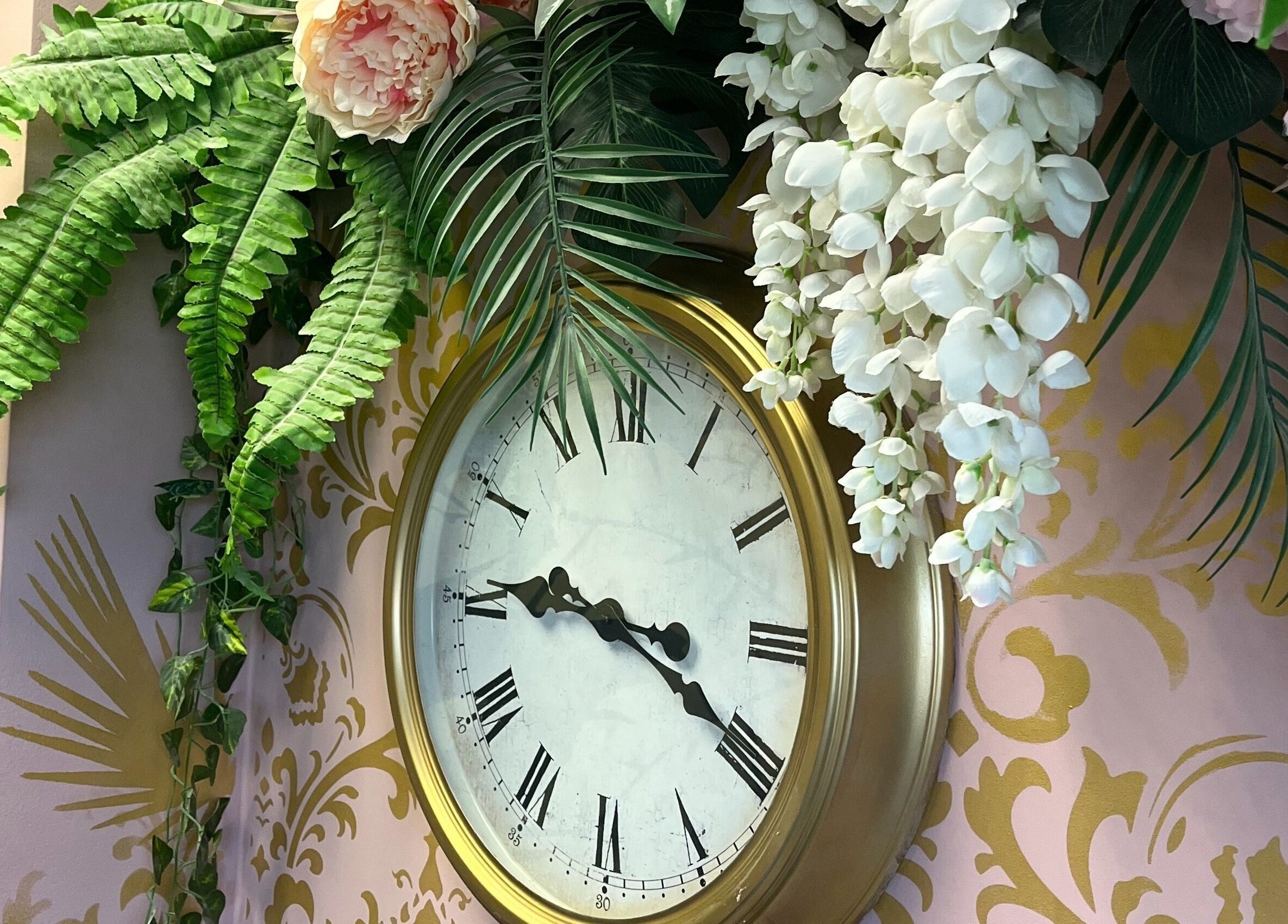 Decorative clock with floral decor at Halo, Newcastle-under-Lyme, England, GB.