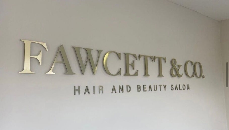 Fawcett & Co. Hair and Beauty Salon signage in Leeds, England, GB on display wall.