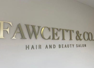 Fawcett & Co. Hair and Beauty Salon signage in Leeds, England, GB on display wall.