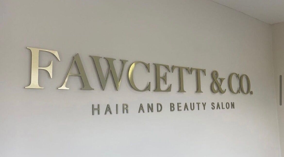 Fawcett & Co. Hair and Beauty Salon signage in Leeds, England, GB on display wall.