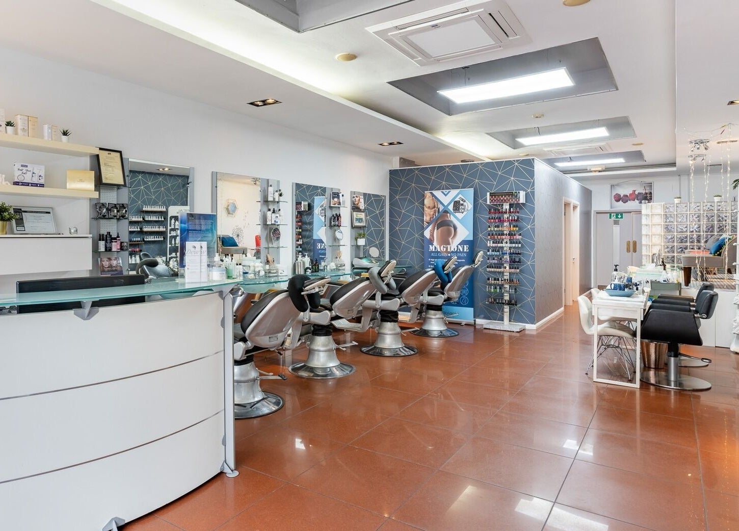 Stylish interior of Dew Beauty and Wellness in London, England, GB showcasing salon chairs and product displays.