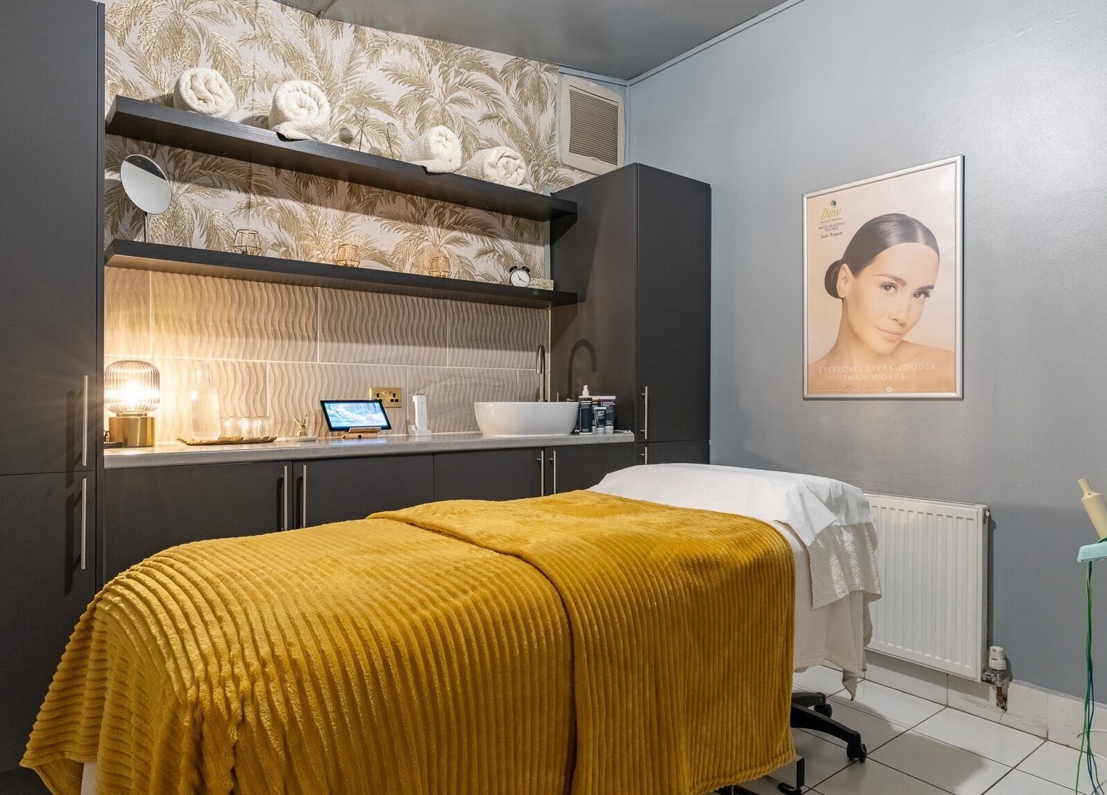Cozy spa room at Dew Beauty and Wellness, London, England, GB, with a treatment bed and elegant decor.
