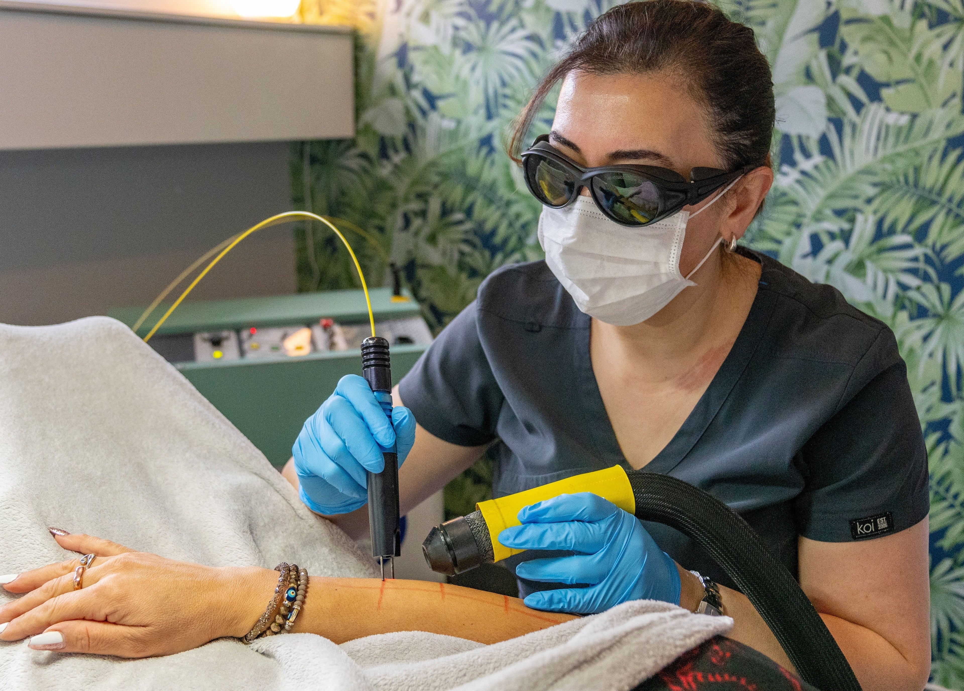 Expert at Dew Beauty and Wellness performing laser treatment, London, England, GB.