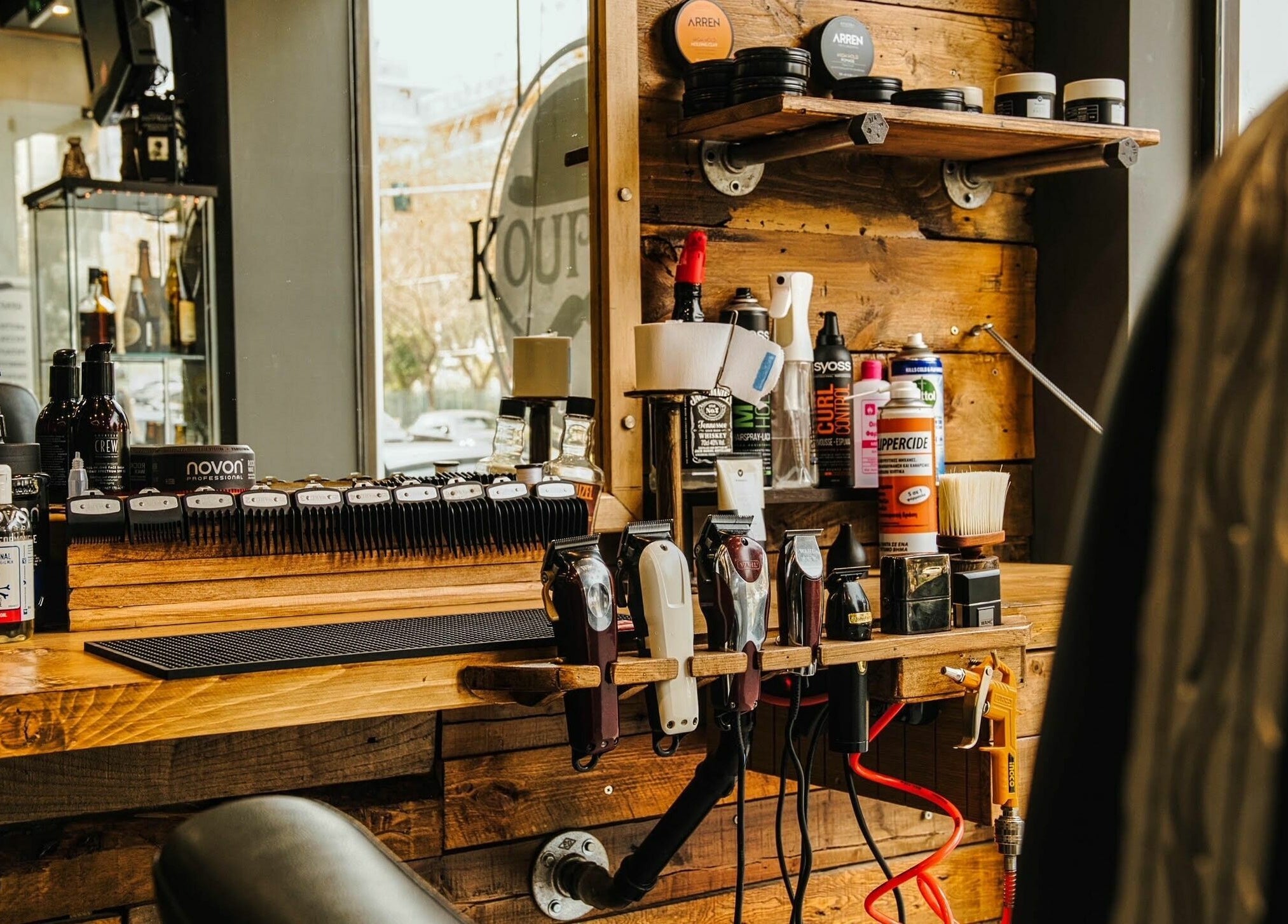 ΚΟΥΡΕΑΣ στο Athina, GR: πλήρως εξοπλισμένος σταθμός κουρέματος με εργαλεία και προϊόντα περιποίησης.