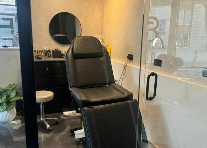Sleek treatment room at Face Base Brighton, Brighton And Hove, England, GB with modern chair and decor.