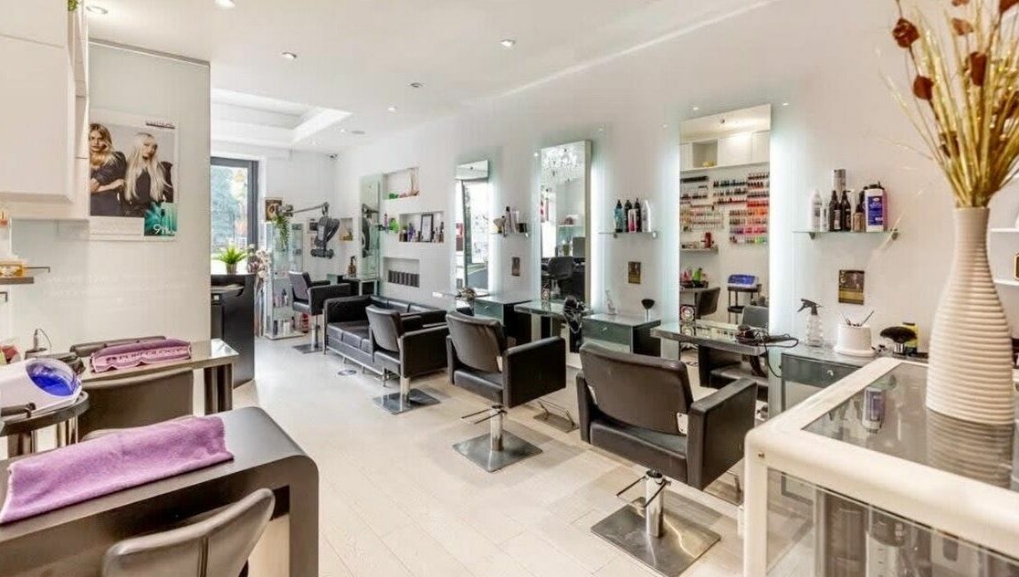 Chic salon interior at Rush&RyNorth Greenwich, London, England, GB, featuring modern styling stations and decor.