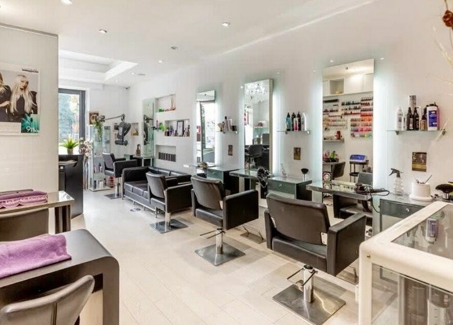 Chic salon interior at Rush&RyNorth Greenwich, London, England, GB, featuring modern styling stations and decor.