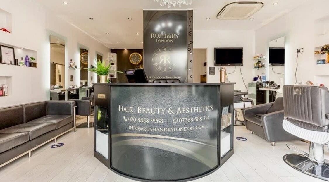 Reception area of Rush&RyNorth Greenwich salon in London, England, GB, featuring modern decor and stylish seating.