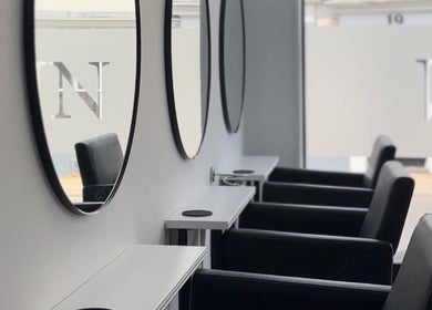 Elegant styling chairs and mirrors at Hun Salon, Alton, England, GB, showcasing modern interior design.