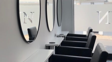 Elegant styling chairs and mirrors at Hun Salon, Alton, England, GB, showcasing modern interior design.