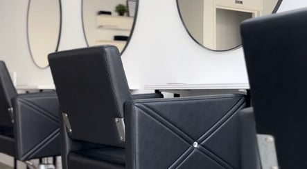 Modern salon chairs and mirrors at Hun Salon, Alton, England, GB, showcasing sleek, stylish design.