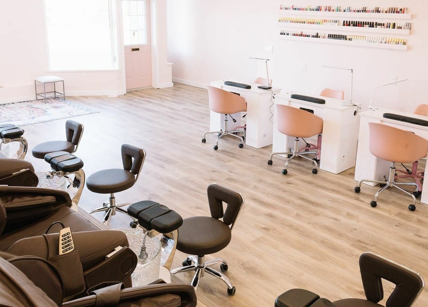 Modern salon interior at Nails & Co. Windsor in Windsor, Ontario, CA, featuring stylish chairs and nail stations.