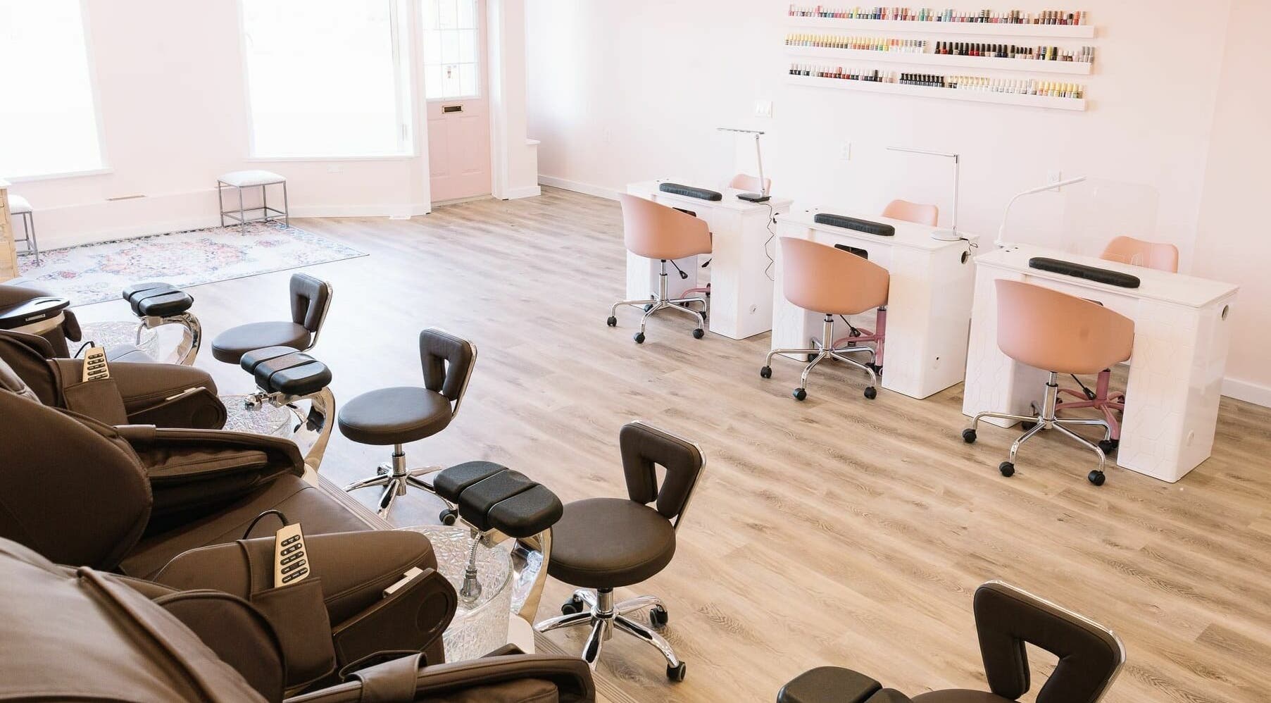 Modern salon interior at Nails & Co. Windsor in Windsor, Ontario, CA, featuring stylish chairs and nail stations.