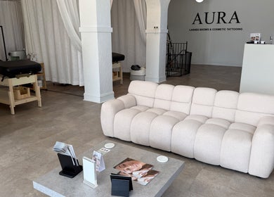 Welcoming seating area at Aura Beauty LLC, Kenosha, Wisconsin, US with a plush sofa and treatment rooms.