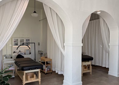 Tranquil treatment room at Aura Beauty LLC, Kenosha, Wisconsin, US, showcasing elegant arches and comfortable beds.