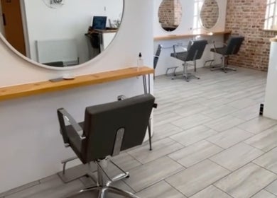 Modern interior of Alice Ellen Hairdressing in Portslade, England, GB, featuring stylish salon chairs and mirrors.