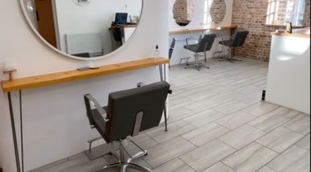 Modern interior of Alice Ellen Hairdressing in Portslade, England, GB, featuring stylish salon chairs and mirrors.
