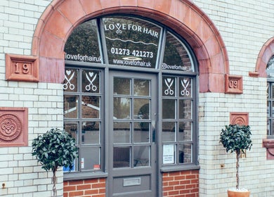 Stylish exterior of Alice Ellen Hairdressing in Portslade, England, GB showcasing elegant signage and decor.