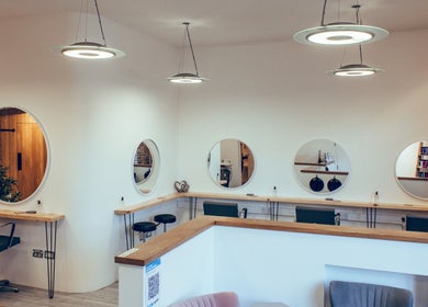 Chic and modern salon setup at Alice Ellen Hairdressing, Portslade, England, GB, featuring stylish mirrors and seating.