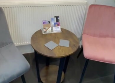 Waiting area at Alice Ellen Hairdressing, Portslade, England, GB with chairs and a small table.