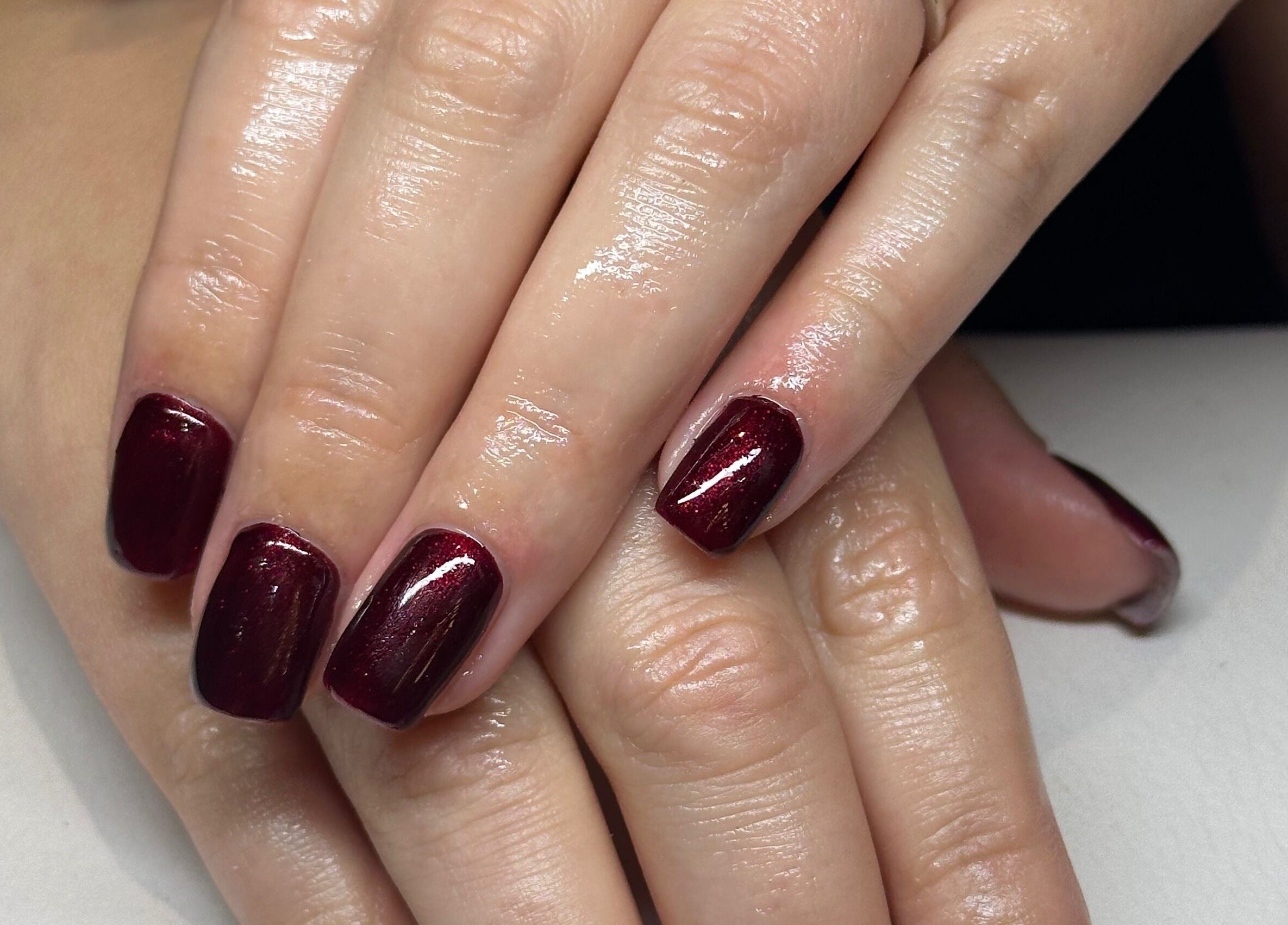 Elegant crimson manicure at The Mani Lounge Cheshire, Congleton, England, GB showcasing glossy perfection.