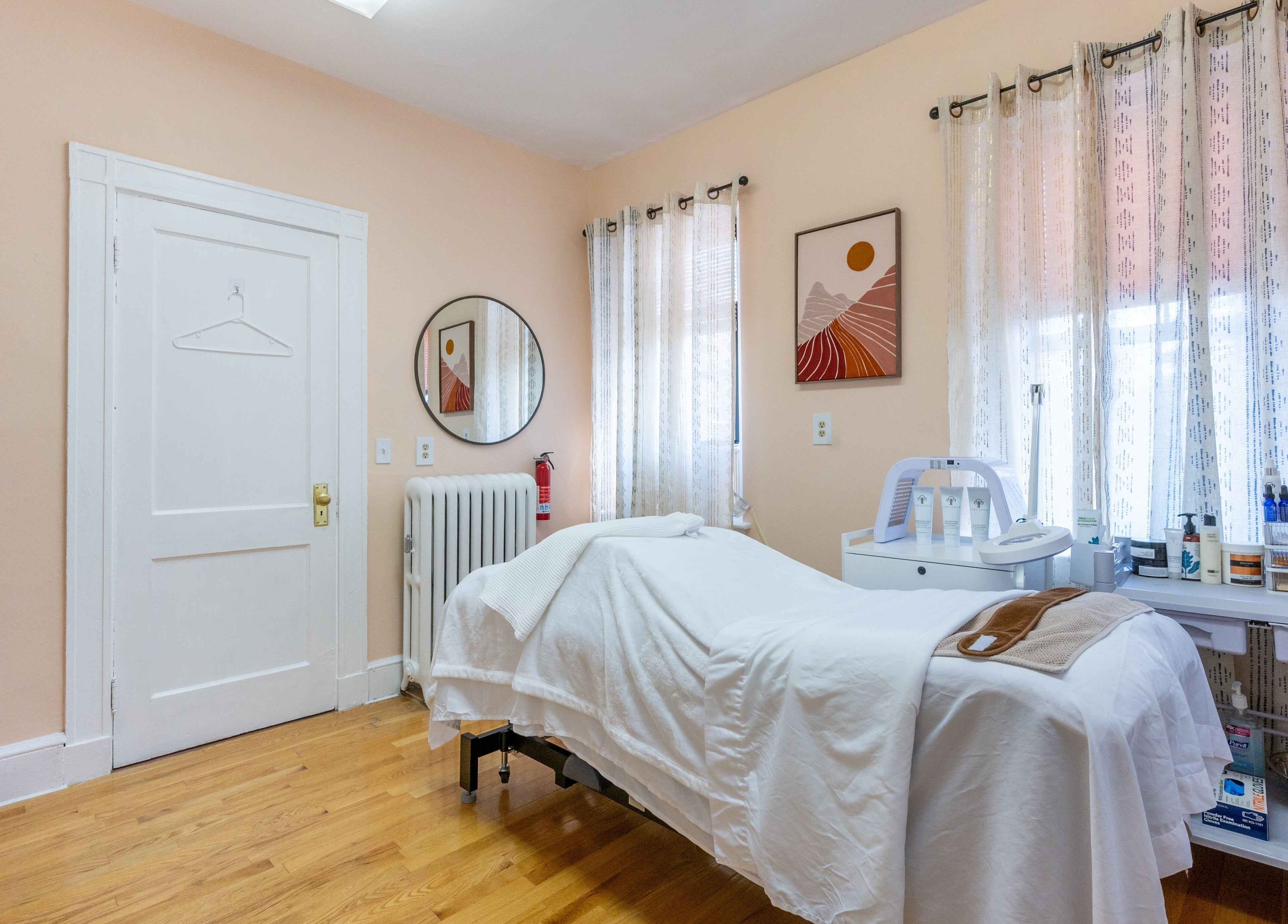 A serene treatment room at PemSpa, Newton, Massachusetts, US, featuring a massage table and soothing decor.