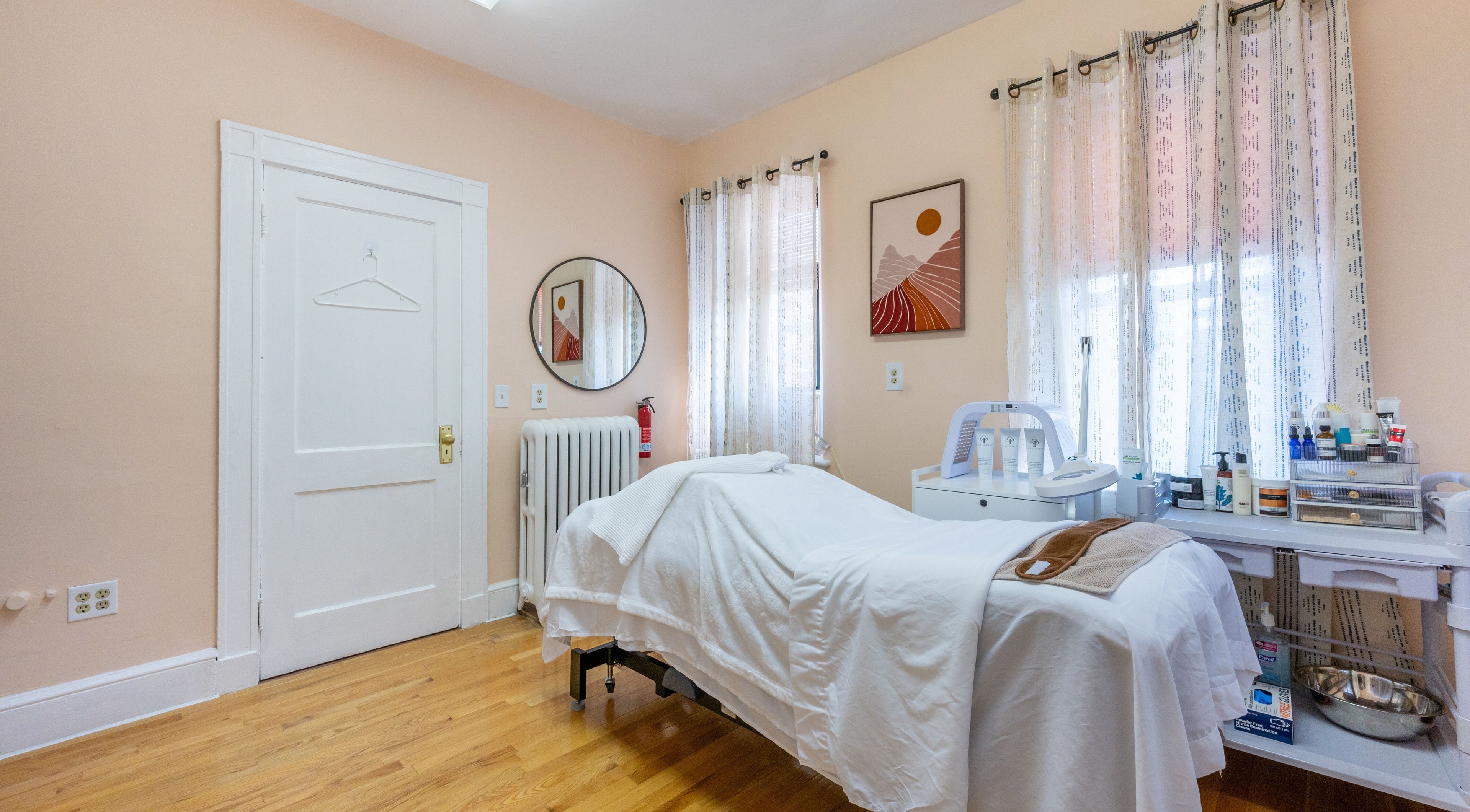 A serene treatment room at PemSpa, Newton, Massachusetts, US, featuring a massage table and soothing decor.